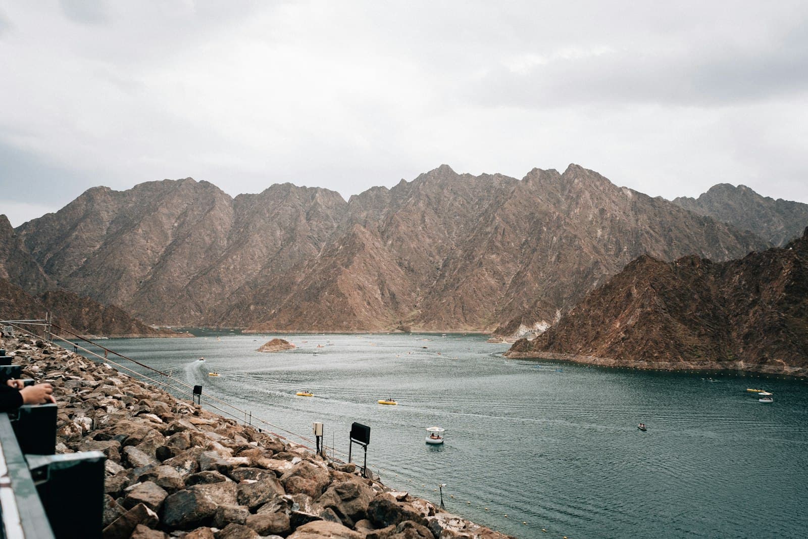 Turquoise water of the Hatta Dam among rocky mountains