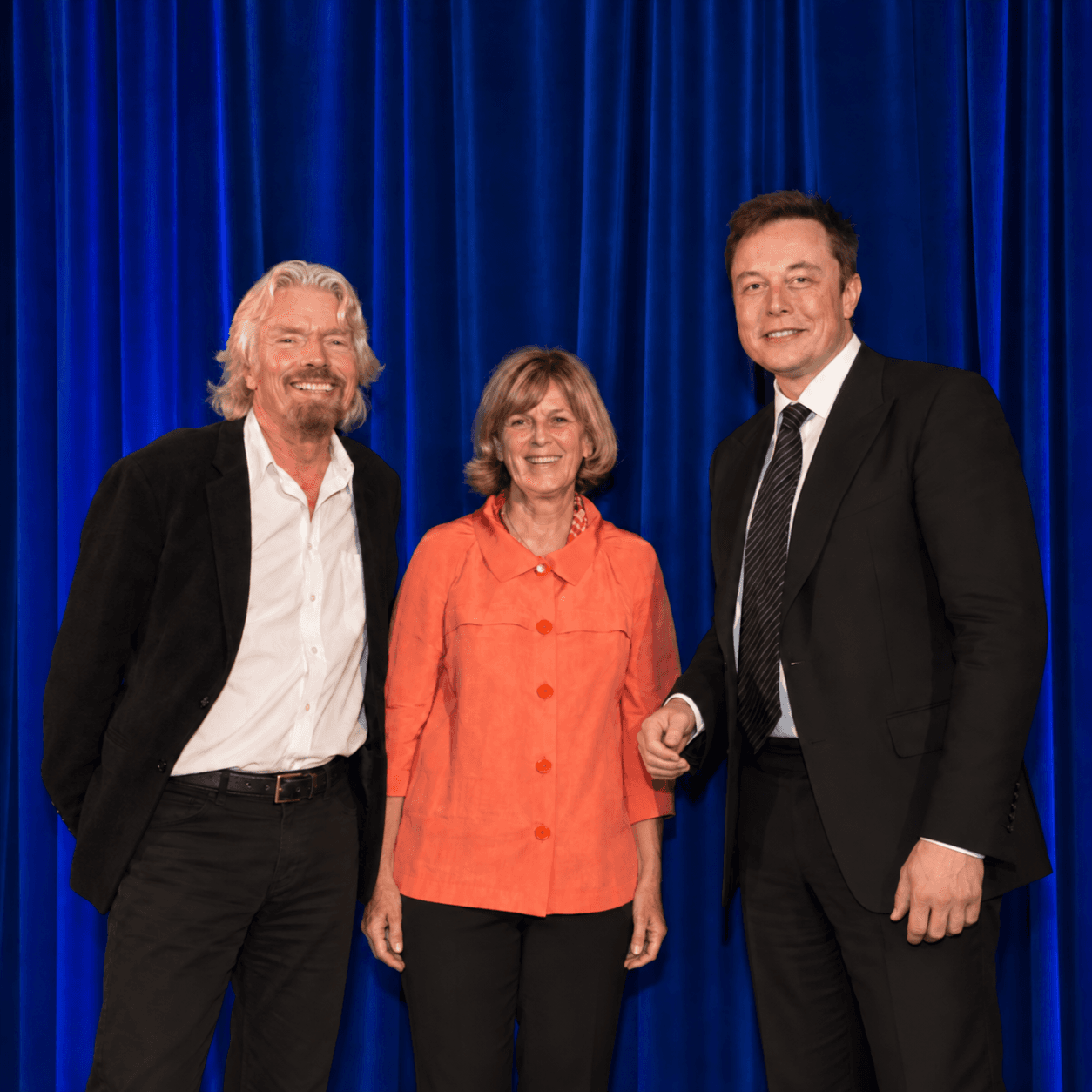 Kathleen Rogers, President of EARTHDAY.ORG, receiving an award between Richard Branson and Elon Musk
